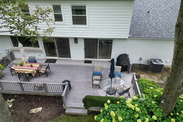Drone view of the existing timber deck, patio furniture and rear elevation before design work