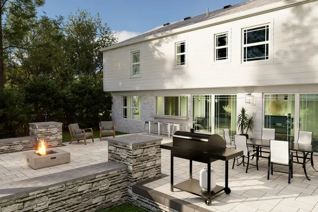 Dusk rendering of the fire pit seating area with the house lit behind